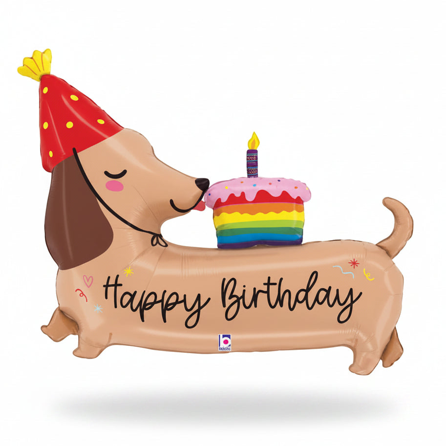 Inflatable dachshund balloon with a birthday cake and candle, wearing a party hat, on a white background.